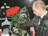 Речь идет о фотоснимке, распространенном агентством Reuters с Люблинского кладбища. Владимир Путин на фоне венков и ограды с повязанными на нее фанатскими шарфами протягивает свой букет роз