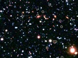 Астрономы поставили два рекорда одновременно: они нашли самое отдаленное от Земли скопление галактик, увидев его в самой ранней из когда-либо отмеченных стадии развития