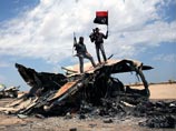 Каддафи ведет переговоры с "дьяволом" в лице ливийских повстанцев, но не покинет страну, заявила его дочь