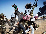 Российский фотожурналист Юрий Козырев занял первое место в категории "Одиночные новости" (Spot News Singles) со снимком "По дороге революции", на котором запечатлены ливийские повстанцы, восставшие против режима Муамара Каддафи