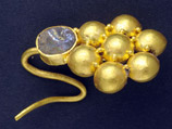 Из почти истлевших лоскутов ткани ученые извлекли 140 монет с профилями императоров Древнего Рима, золотое кольцо с печатью и серьгу в форме цветка