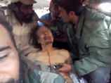 Неизвестное видео с убитым Каддафи: повстанцы забавляются с его телом, как с куклой