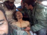 Неизвестное видео с убитым Каддафи: повстанцы забавляются с его телом, как с куклой Неизвестное видео с убитым Каддафи: повстанцы забавляются с его телом, как с куклой