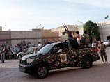 Ранее в тот вооруженная группировка численностью до 200 человек окружила здание МИДа страны на автомобилях с установленными на них зенитными орудиями и потребовали уволить всех чиновников, связанных с режимом Муаммара Каддафи
