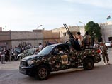 Ранее в тот вооруженная группировка численностью до 200 человек окружила здание МИДа страны на автомобилях с установленными на них зенитными орудиями и потребовали уволить всех чиновников, связанных с режимом Муаммара Каддафи Ранее в тот вооруженная группировка численностью до 200 человек окружила здание МИДа страны на автомобилях с установленными на них зенитными орудиями и потребовали уволить всех чиновников, связанных с режимом Муаммара Каддафи