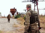 Ополченцы Донецкой народной республики (ДНР) на месте захоронения мирных жителей, найденного в районе шахты "Коммунар" под Донецком, 25 сентября 2014 года Ополченцы Донецкой народной республики (ДНР) на месте захоронения мирных жителей, найденного в районе шахты "Коммунар" под Донецком, 25 сентября 2014 года