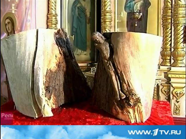 Распятие с фигуркой Христа, словно сросшееся со стволом дерева, сейчас установлено у алтаря храма