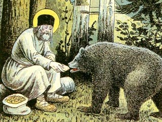 Современники Серафима Саровского особо отмечали, что святой исцелял не столько кротким словом, сколько любовью и радостью, исходившими от него. На фото - народная лубочная картинка 'Святой Серафим кормит медведя'