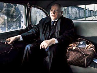 На этой фотографии Горбачев сидит в автомобиле, а рядом с ним стоит дорожная сумка Louis Vuitton