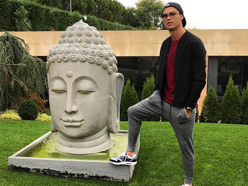 Фотография футболиста мадридского "Реала" Криштиану Роналду, поставившего ногу на пьедестал статуи с головой Будды, вызвала возмущение буддистов всего мира